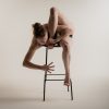 performing artist freya pellie contorts self on chair