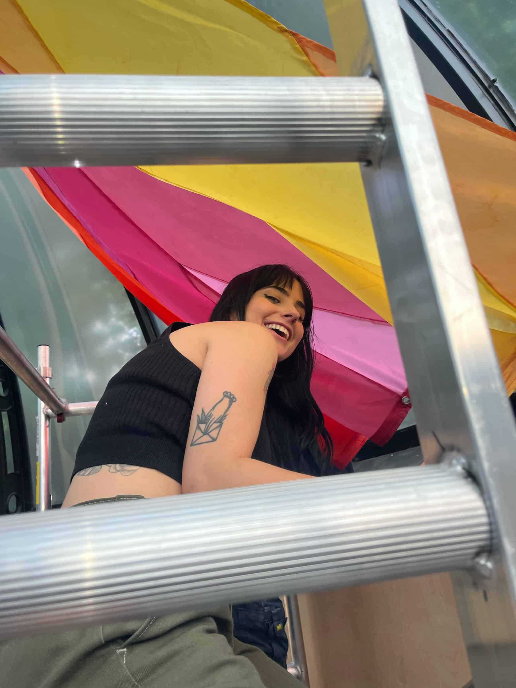 artist Zeena-Wright smiling under ladder