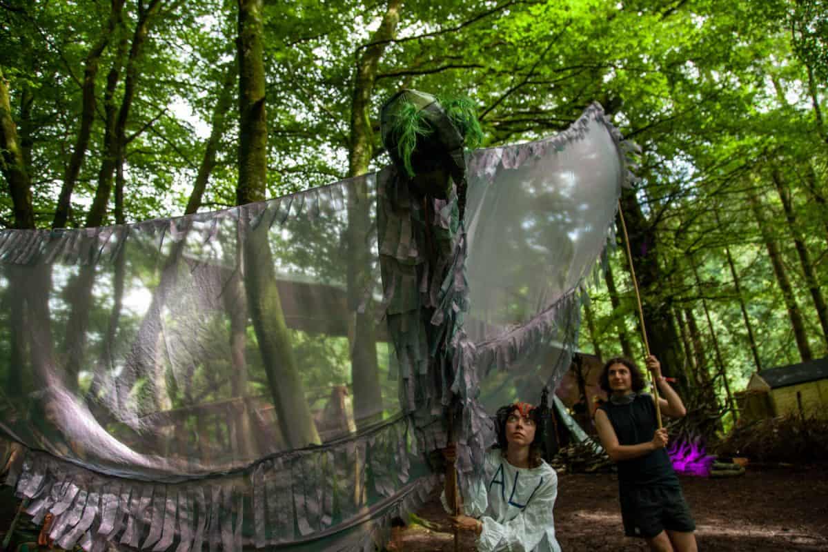 actor holds winged puppet for microsteria in neverending glen